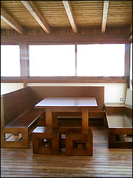 Mobiliario y parqu&eacute; bajo la p&eacute;rgola